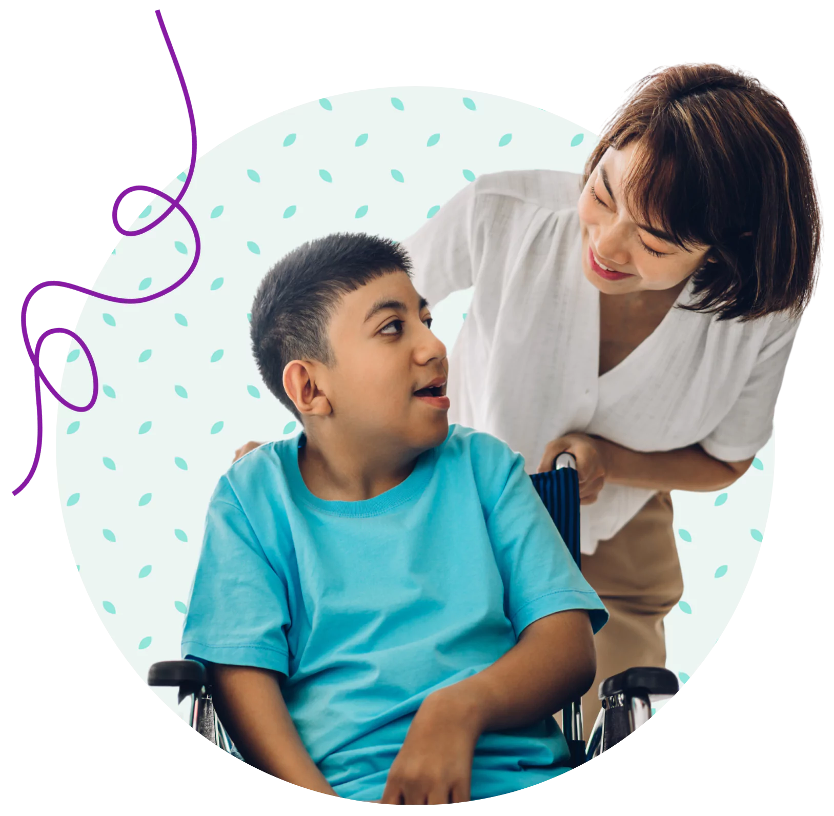 A young disabled boy smiling with his care giver